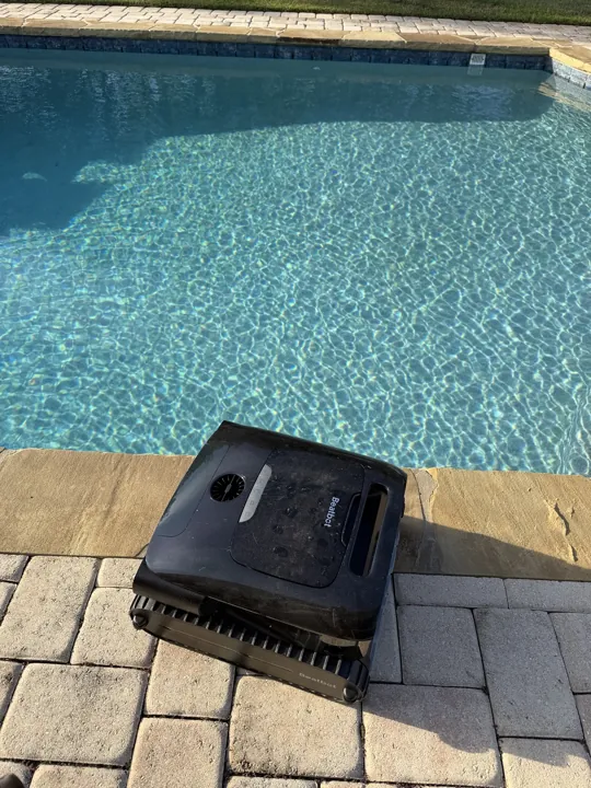 Nicholas’s Beatbot A200 Pro pool cleaner beside his pool